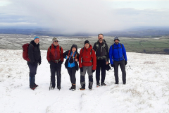 Dec-25_5-Trigs-and-Trods_Happy-group-on-Black-Hill-scaled_Photo-Ian-Helliwell