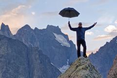 August-2023-Paul-Taylor-on-boulder-overlooking-Pelvoux.-Photo-Rachel-Johnston
